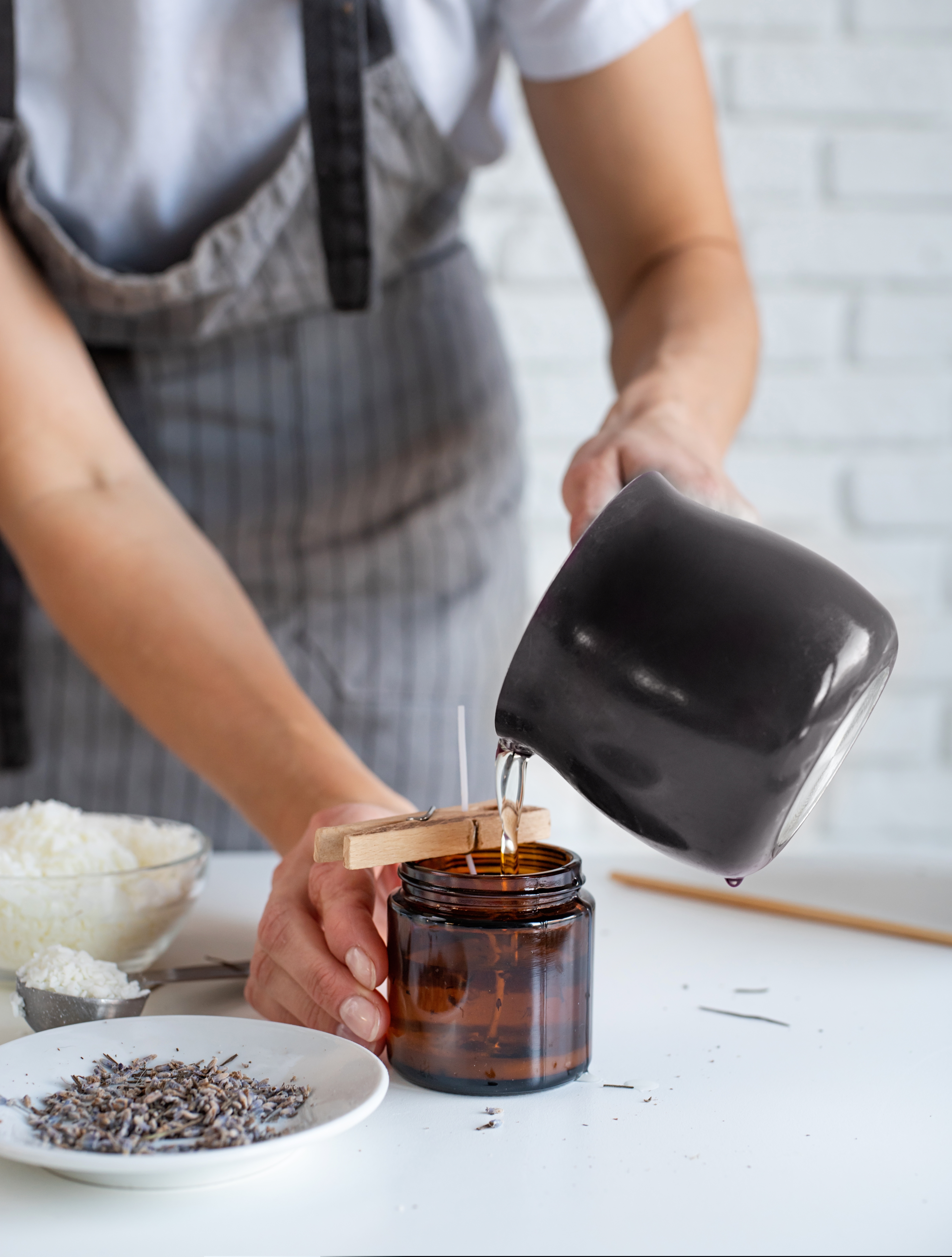 Woman pouring wax into a jar