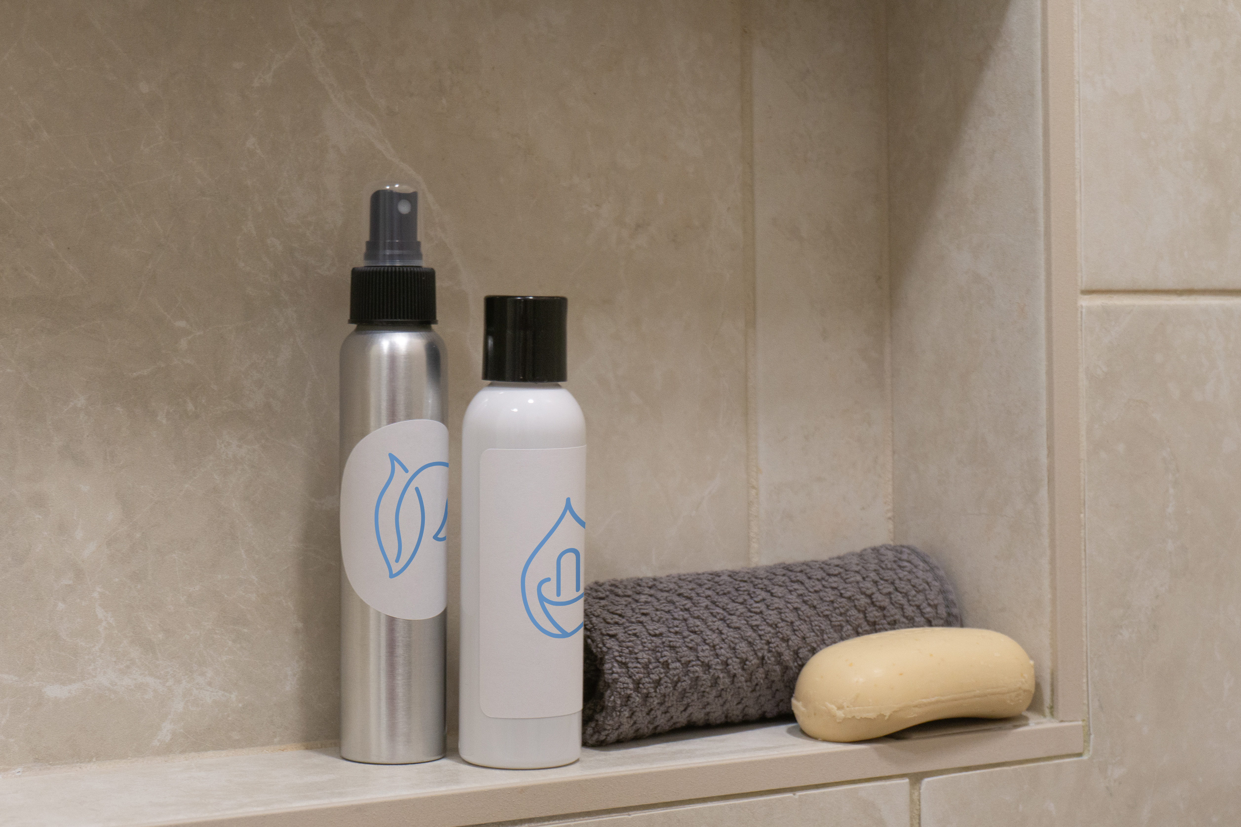 Two bottles on a shower wall shelf