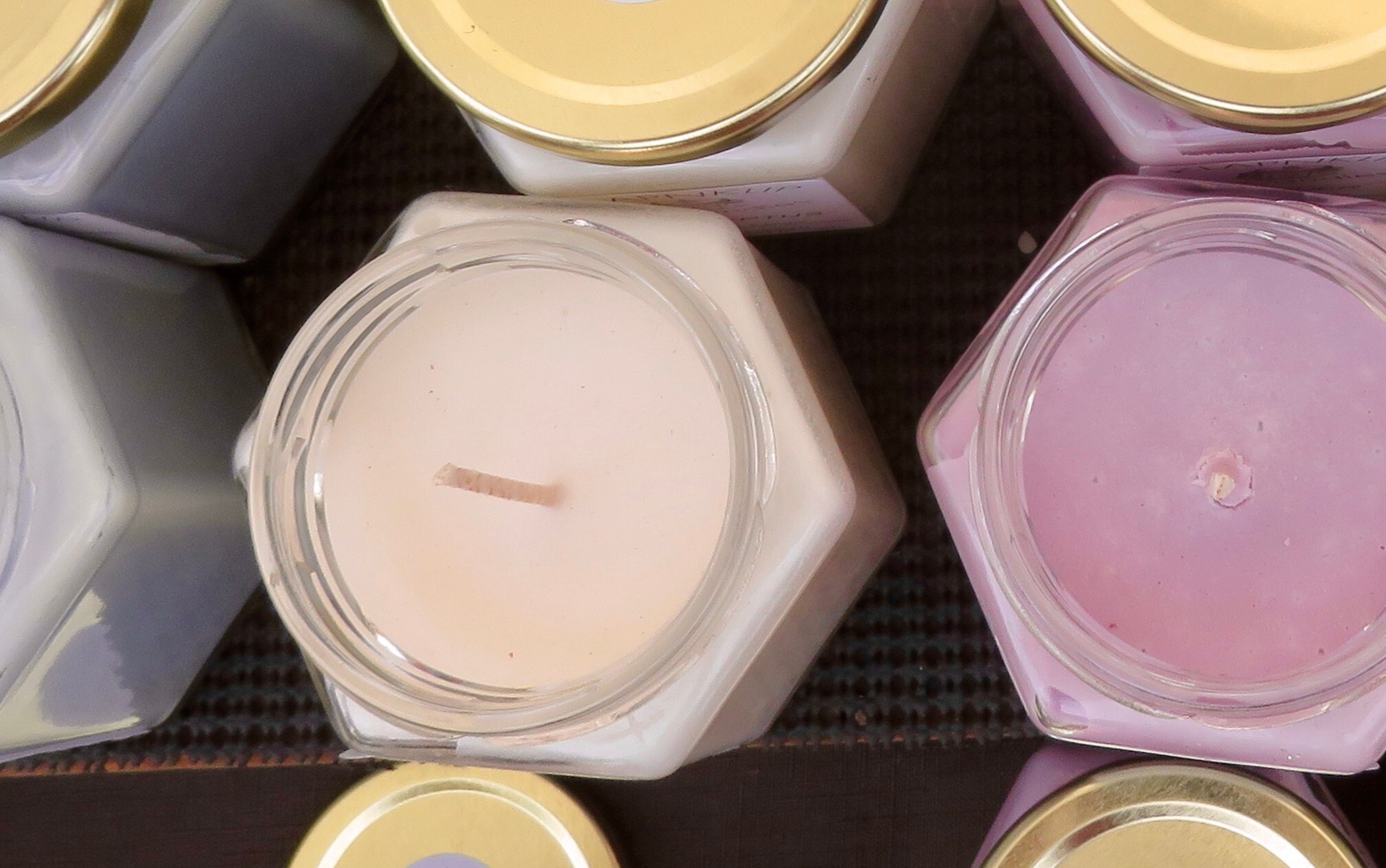 Hexagonal candle jars filled with colorful wax