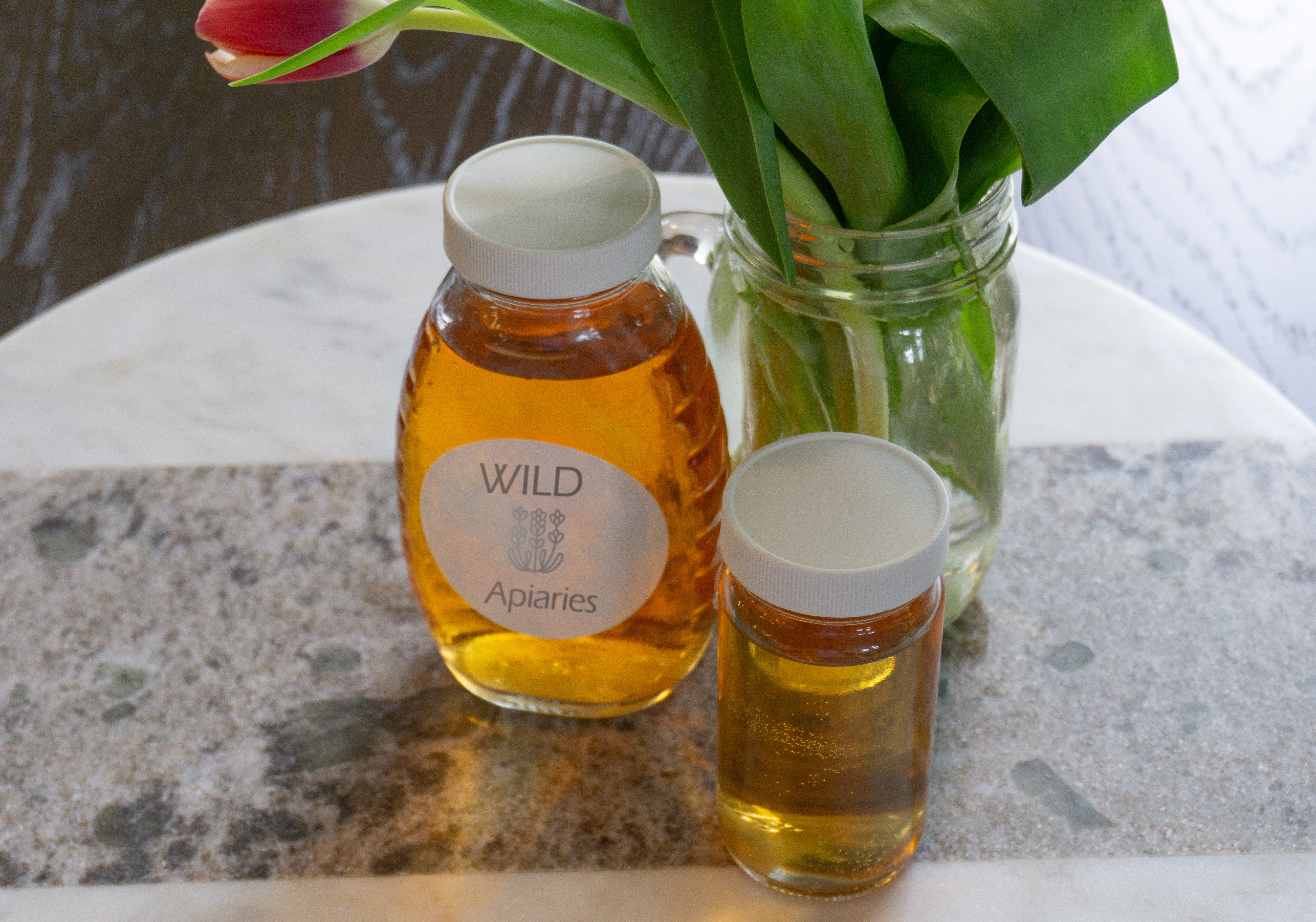 glass honey bottles on a table