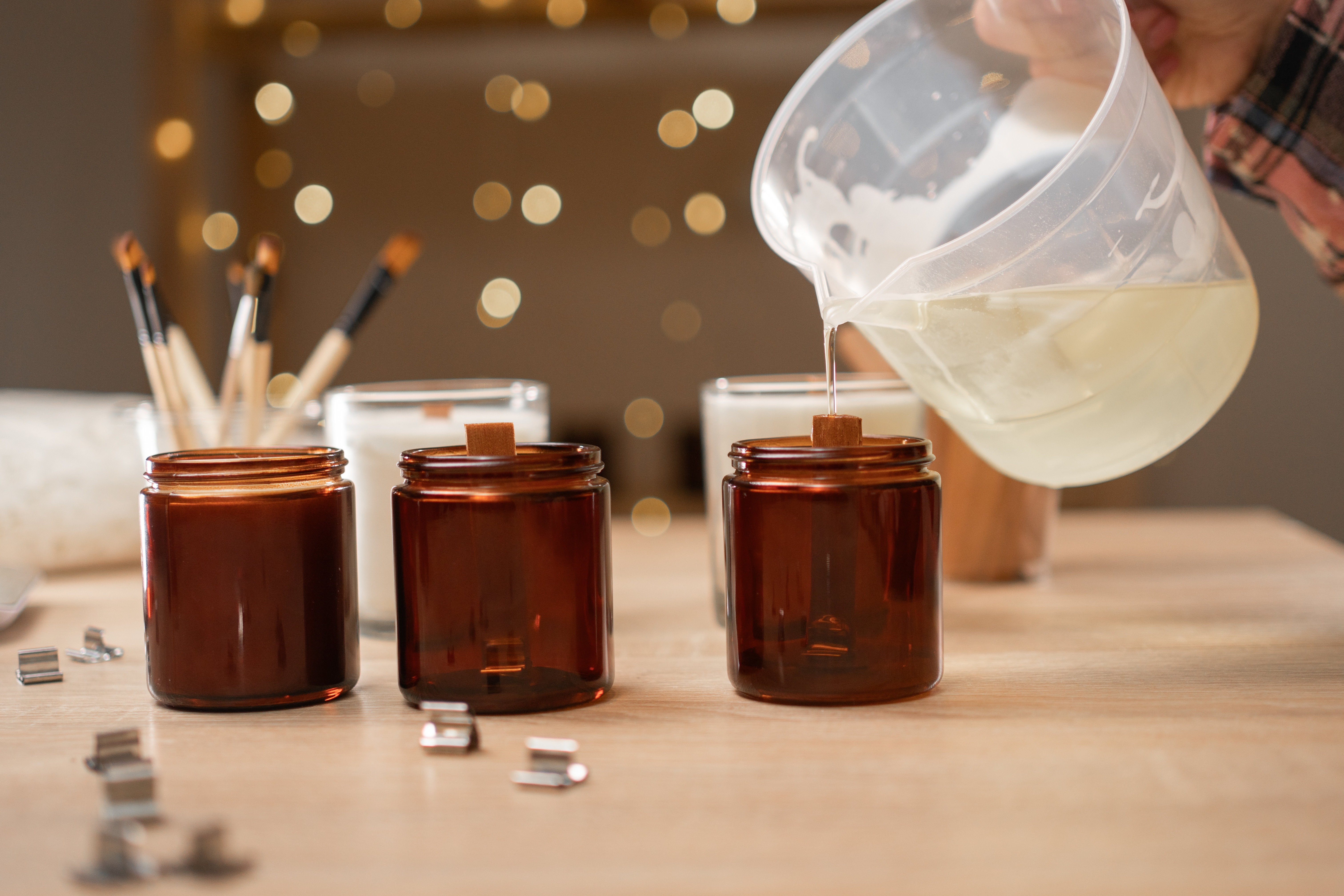 Pouring wax into amber candle jars